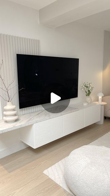 Cheryl | Interiors & Garden UK on Instagram: "D I Y  T V  W A L L - Evening all…..i haven’t shared this wall in so long. I designed this space over 3 years ago now and i still love it. - We used the @ikeauk Besta TV unit that can be wall mounted. Then we added the Laxviken door fronts in white, also from @ikeauk  - The shelf that sits on the TV unit is a laminate worktop from @bandq_uk - we cut it to size, added some matching edging strip and then screwed it from underneath to hold it on. - The panelling was made from mdf boards that were cut to strips - also from @bandq_uk it was painted in Farrow and Ball Armonite - colour matched by Valspar. - The tv is 65” @lg_uk  - The walls are painted in @duluxuk White cotton 🤍 - Any questions please ask away…. Xx - DIY TV wall | TV wall design | L Wall Decor Tv Mounted Tv, Tv Board Living Room, Tv Wall Ideas Living Room Small Spaces, Small Living Room Tv Wall Ideas, Besta Tv Unit Ideas, Ikea Tv Wall, Tv Wall Design Small Space, Besta Tv Unit, Diy Tv Wall