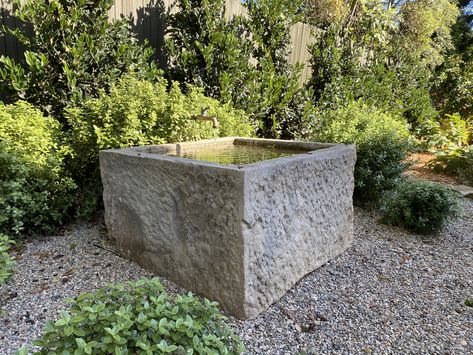 This antique French limestone trough from @eyeofthedaygdc converted into fountain with antique spout with pittosporum “golf ball” in pea gravel Farmhouse Gardens, Limestone Trough, Limestone Fountain, Stone Trough, Curb Appeal Landscape, Fountain Ideas, Backyard Renovation, French Limestone, Backyard Renovations