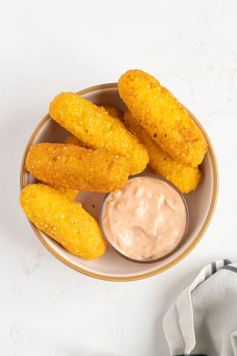 These Puerto Rican fried corn fritters, aka sorullos (also sometimes called sorullitos), are made with a cheesy cornmeal dough and come together in just 30 minutes. They make an easy and delicious snack or appetizer served with mayoketchup or a cup of café con leche. Fried Corn Fritters, Latina Food, Latin Desserts, Sofrito Recipe, Hispanic Dishes, Recetas Puertorriqueñas, Lunch Options, Puerto Rican Cuisine, Puerto Rican Dishes