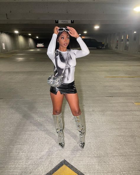 Chrome Boots Outfit Ideas, Metallic Baddie Outfit, Mini Skirt And Knee High Boots Outfit, Metalic Heel Outfit, Black Mini Skirt Outfit Baddie, Silver Knee Boots Outfit, Outfits With Leather Mini Skirt, Black And Silver Outfits Black Women, Silver Metallic Boots Outfit Black Women