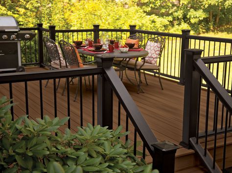 Paint the trellis dark???  decking in Tudor Brown with Mission rail in black and metal balusters Dark Deck, Metal Balusters, Deck Railing Design, Deck Makeover, Black Deck, Deck Colors, Storage Inspiration, Deck Paint, Staining Deck