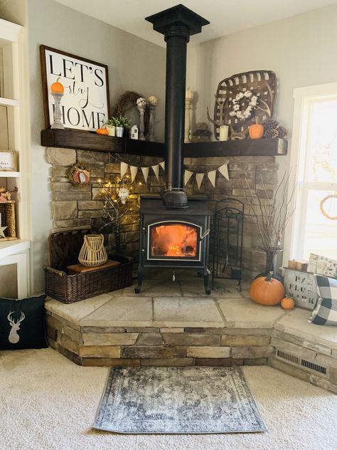 #woodstove #homedecor #cornermantle #farmhouse #fall #falldecor #mountains Raised Woodstoves, Woodstove Mantle Decor, Wood Stove Area Ideas, Wood Burning Stove Corner Farmhouse, Farmhouse Wood Stove Hearth, Wood Stove Mantle, Wood Burning Stove Living Room, Woodstove Mantle, Corner Wood Stove Ideas