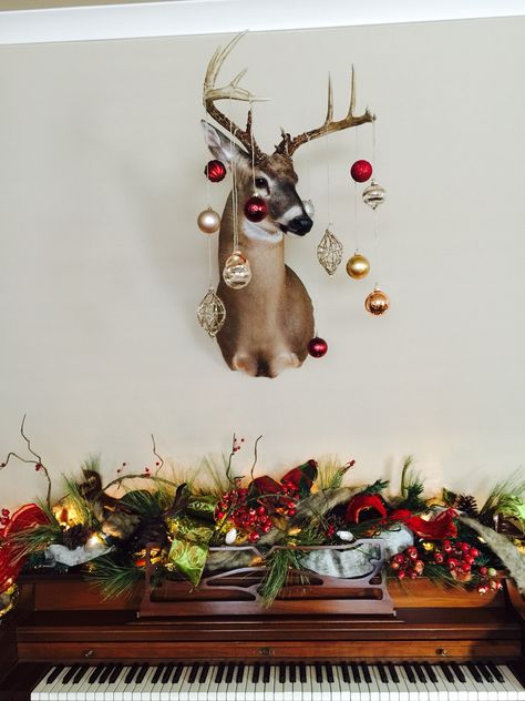 Deer Mount Over Fireplace Christmas, How To Decorate Deer Mounts For Christmas, Decorate Deer Mount For Christmas, Decorating Deer Mounts For Christmas, Deer Head Christmas Decor, Piano Christmas Decor, Antler Christmas Decor, Deer Mount Decor, Piano Christmas