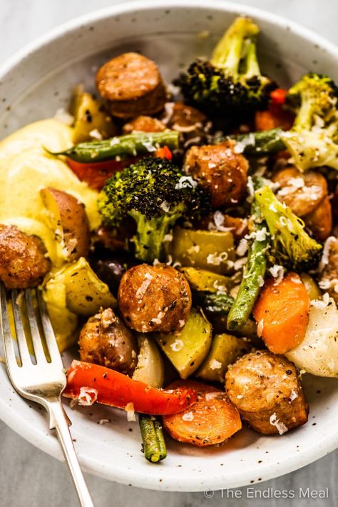 PIN TO SAVE! Sheet pan sausages and veggies is our go-to quick and easy dinner recipe. It's a delicious recipe that helps to clear out your fridge and makes almost no dishes. You'll love it! #theendlessmeal #sheetpandinner #sausages #sausagedinner #sheetpansausages #bakedsausages #easydinners #easymeals Sheet Pan Sausage And Veggies, Pan Sausage And Veggies, Sheet Pan Sausage, Sausage And Veggies, Sausage Dinner, Sheet Pan Dinners Chicken, Paleo Friendly Recipes, Italian Sausage Soup, Veggie Dinner