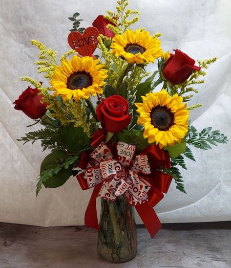 Our most popular pairing of flowers! Sunflowers and red roses accented with golden aster, a heart pic and Valentine bow. Valentine's 💘 Day is Monday, Feb. 14th. #jensensflowersandgifts #shoplocal #roses #TellYourLoveStorywithFlowers #flowers #handcrafted #bouquet #flowerlove #iloveyou #sweetie #sweetheart #valentines #valentinesday #feb14th #love #heart Sunflower And Rose Arrangements, Sunflowers And Red Roses, Red Roses And Sunflowers, Sweetheart Valentines, Heart Pic, Feb 14th, Sunflower Love, Flowers Sunflowers, Sunflower Vase