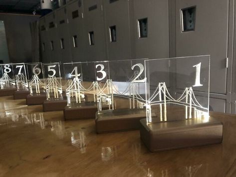 My Sister Wanted Lit LED Table Numbers So I Put These Together For Her! The Bases As 3D Printed To Hide The Wires. My Daughter (Their Niece) Sketched The Bridge Where They Got Engaged And I Then Laser Engraved The Sketch Into Clear Acrylic So It Would Glow. Really Happy With How These Turned Out! Paper Bridge, Glow Stick Wedding, Laser Engraved Wedding, Diy Wire Jewelry Rings, Rustic Beach Wedding, Wire Jewelry Rings, Diy Wedding Dress, Got Engaged, Handcrafted Decor