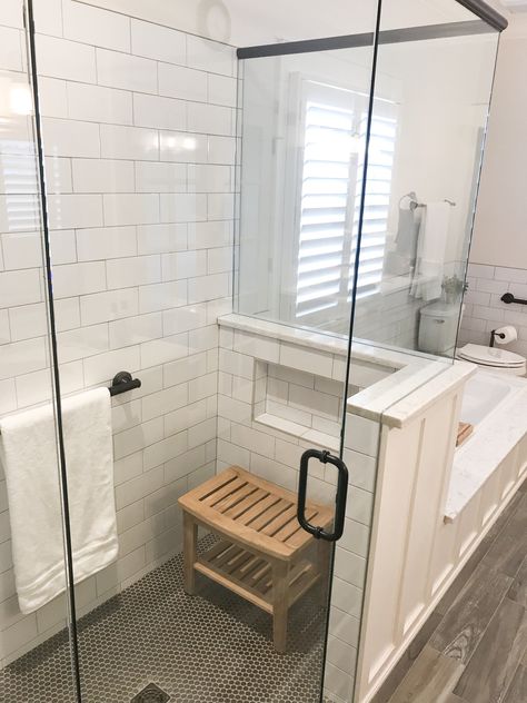 Shower Half Wall With Niche, Half Tiled Shower Wall, Oversized Shower Tile, Shower Niche In Half Wall, Penny Tile Bathroom Shower Floor, Oversized Subway Tile Bathroom, Tile Shower With Niche And Bench, Subway Tile Niches In Showers, Hidden Shower Niche