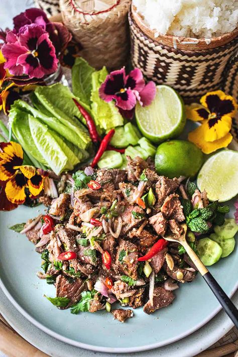 This authentic Thai beef larb recipe is a super tasty and popular dish from Isaan (Northeastern )Thailand. It's a flavorful salad made with near-raw, thinly sliced beef. This tasty Thai larb has a wonderful assortment of fresh herbs that bring out the bold, addictive flavors. It's an easy recipe, and it's extra healthy! #beeflarb #beeflaab #beeflarbrecipe #authenticbeeflarb #thailarb #thailaab #thailaabrecipe #authenticlaabrecipes Beef Larb, Thai Laab Recipe, Beef Larb Recipe Thai, Chicken Larb Recipes Thai, Larb Recipe Thai, Laab Recipe, Thai Larb, Thai Beef Salad Recipe, Larb Recipe