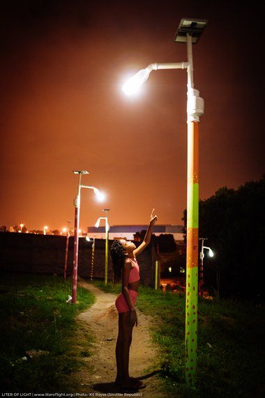 Girl stands under solar powered street light in Rio Standing Under Street Light, Solar Powered Street Lights, Cheap Solar, Urban Intervention, Silent Killer, Solar Lighting, Solar Power Diy, Solar Powered Lights, Girl Standing