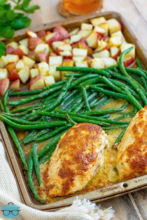 Garlic Parmesan Chicken on a sheet pan with green beans and red potatoes.