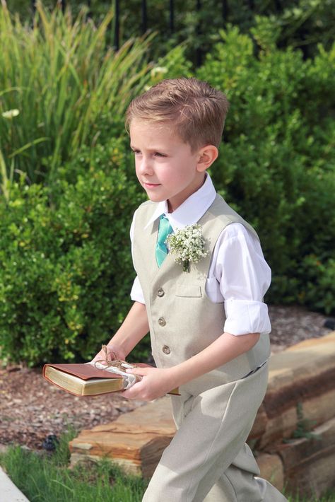 Ringbearer uses Bible to hold rings Sage Green Ring Bearer Outfit, Ring Bearer Sage Green, Ringbearers Outfits, Unique Yellow Gold Engagement Ring, Oval Wedding Band, Wedding Coral, Woods Wedding, Groom And Groomsmen Suits, Ring Bearer Flower Girl