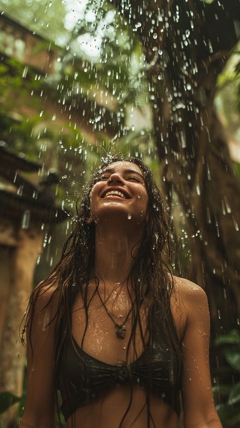 In the midst of a serene natural backdrop, a woman is immersed in a moment of pure bliss as the rain showers down upon her. The water droplets are illuminated against the verdant environment, drawing attention to the woman's joyful expression. This scene captures the essence of finding happiness in simple pleasures, surrounded by the beauty of nature. Woman Shower Aesthetic, Smile Asthetic Picture, Pure Happiness Aesthetic, Pure Joy Aesthetic, Living Your Best Life Aesthetic, Wellness Aesthetic Black Woman, Blissful Aesthetic, Happy Person Aesthetic, Spiritual Woman Aesthetic