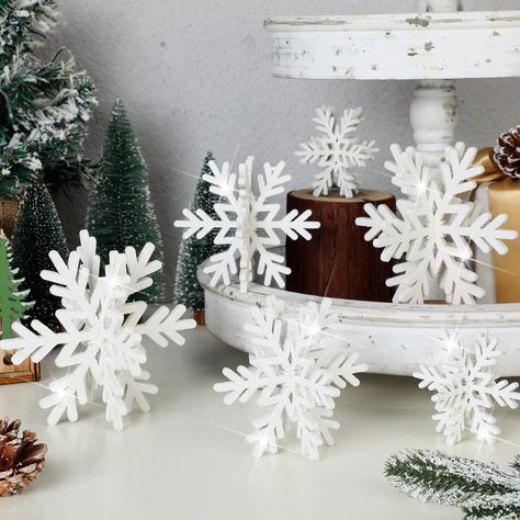 White dinnerware with silver cutlery, crystal glassware, and white candles in silver holders. Snowflake Centerpieces, Wonderland Decorations, 3d Snowflake, Snowflake Baby Shower, Winter Wonderland Decorations, Christmas Tabletop Decor, Cake Table Decorations, Christmas Fireplace Decor, Wooden Snowflakes