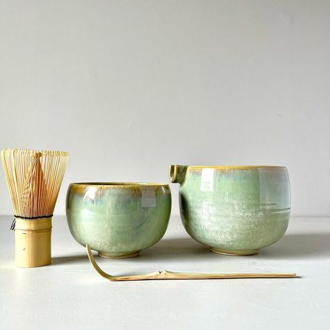 A matcha bowl set with a mixing bowl and a separate drinking bowl offers a convenient and traditional way to prepare and enjoy matcha tea. Here’s how you can use each component: 1. Mixing Bowl (Chawan): This bowl is used for whisking and mixing the matcha powder with hot water. Add the desired amount of matcha powder into the mixing bowl. 2. Whisk (Chasen): Use the bamboo whisk to froth and mix the matcha powder with hot water in the mixing bowl. Hold the whisk in one hand and whisk vigorou... Matcha Mixing Bowl, Bamboo Whisk, The Matcha, Bowl Cake, Matcha Bowl, Wheel Thrown Pottery, Matcha Powder, Candle Vase, Matcha Tea