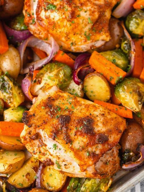 Whip up this Chicken Thigh Tray Bake for a fuss-free meal that's loaded with flavor! With juicy chicken thighs, colorful veggies and a sprinkling of seasonings, everything roasts on one sheet pan for maximum flavor and easy cleanup! Chicken Thigh Tray Bake Recipes, Boneless Skinless Chicken Thigh Recipes Baked, Chicken Thighs And Veggies, Chicken Tray Bake Recipes, Traybake Dinner, Juicy Chicken Thighs, Sheet Pan Meals Chicken, Chicken Tray Bake, Colorful Veggies