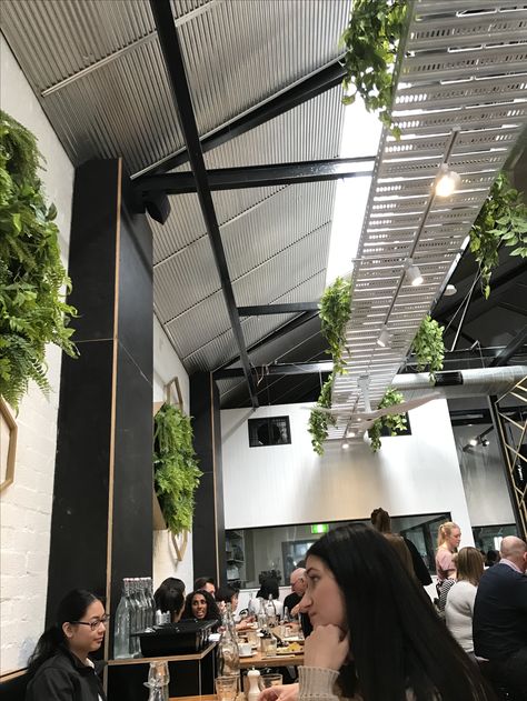 Cable trays and plants! Cable Tray Ceiling Interior Design, Light Cables Ceiling, Cable Tray Ceiling, Cable Tray Lighting, Black Ceiling Cafe, Suspended Lights Office, Greenery Ceiling Restaurant, Cafe Ceiling, Ceiling Plants Hanging Restaurant