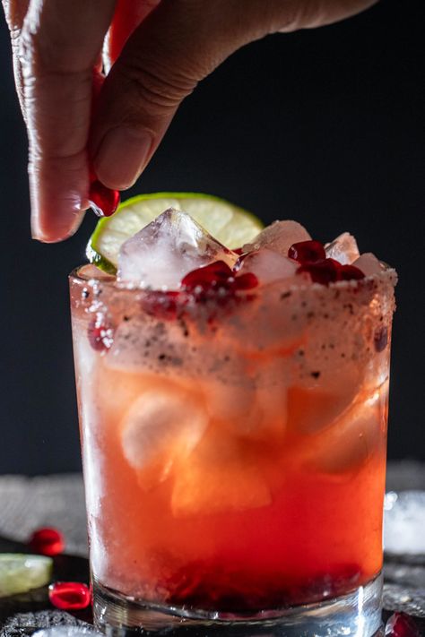 A vibrant fusion of pomegranate and tequila in a refreshing Pomegranate Tequila Margarita. A cocktail for any occasion. Tequila Pomegranate Cocktails, Pomegranate Tequila Drinks, Pomegranate Rum Cocktail, Mediterranean Cocktail Recipes, Thanksgiving Margarita Pitcher, Pomegranate Margaritas, Pomegranate Tequila, Pomegranate Cocktail, Coconut Tequila