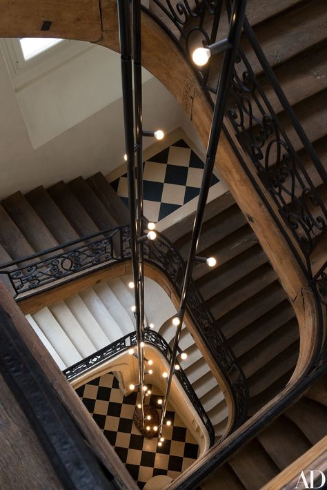 Yovanovitch designed a 45-foot-long light fixture, composed of three black metal rods, for the main staircase of his Paris office. Parisian Office, Victorian Staircase, White Staircase, Pierre Yovanovitch, Parisian Architecture, French Apartment, Wood Staircase, Stairway To Heaven, Staircase Design