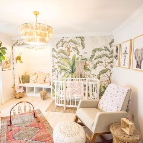 a bright tropical nursery with a tropical printed wall, a tassel chandelier, boho rugs, a leather ottoman and printed pillows Nursery Ideas Tropical, Tropical Rainforest Nursery, Tropical Themed Nursery, Jungle Nursery Girl, Boho Jungle Nursery, Tropical Nursery, Girl Nursery Room, Jungle Nursery, Baby Room Design