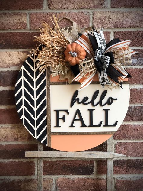 We offer a wide variety of wooden door hangers to spruce up your front door!  Description: Welcome the cozy vibes of autumn with our stunning Hello Fall Door Hanger, perfect for adding a touch of warmth and charm to your front door! Handcrafted with care, this door hanger is available in two sizes, 18" and 22", and features high-quality materials and craftsmanship. Product Features: Sizes: Choose between 18 inches and 22 inches in diameter. Thickness: Sturdy 1/2 inch thickness for durability. 3D Fall Door Rounds, Black Fall Porch Decor, Aztec Fall Decor, Fall Wooden Wreath, Hey Pumpkin Door Hanger, Last Name Wooden Door Hangers, Front Door Fall Wreaths, Diy Front Door Welcome Sign, Door Hanger With Attachments