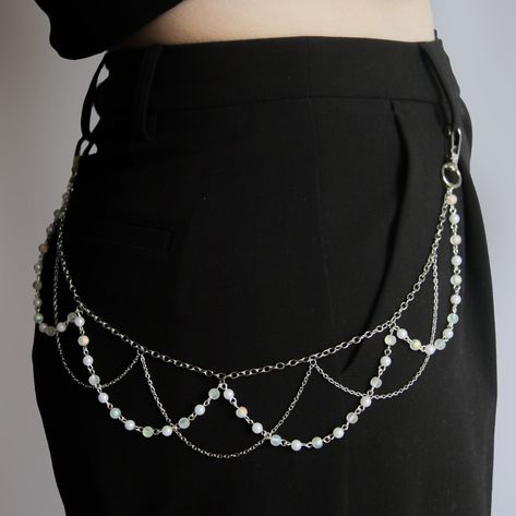 Introducing the beaded belt chain, a must-have accessory to elevate your wardrobe effortlessly. Crafted with meticulous attention to detail, this chain features a stunning layering of silver chains intertwined with delicate beaded strands. The beaded chains, adorned with lustrous pearls and clear rainbow beads, exude timeless elegance and versatility, seamlessly complementing any outfit, regardless of its colour or pattern. Instantly transform your look with a touch of sophistication and charm as this chain effortlessly adds style, interest, and beauty to any ensemble. Whether paired with pants or skirts, this accessory is the perfect finishing touch to showcase your unique sense of fashion.  specifications: Length is 52 cm  (DM me if you need a shorter or longer length) Stainless Steel Lo Chain Accessories Fashion, Strings Of Beads, Clothes With Chains, Beads Outfit, Jewelry Belt, Chain Waist Belt, Diy Waist Chain, Beaded Belts, Beads Chain