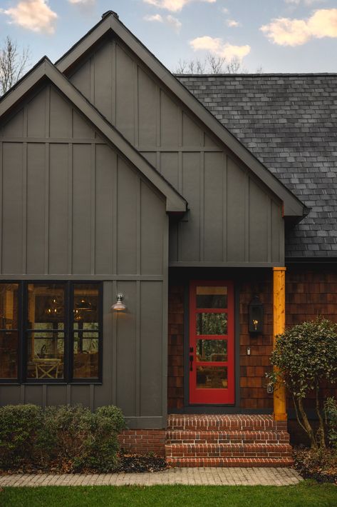 Black House Red Trim, Dark Blue And Red Brick House, Red Brick And Dark Siding, House Siding Color Ideas, Dark House Exterior Colors, Green House Red Door, Board And Batten Siding With Brick, Dark Gray House Exterior, Dark Green House Exterior