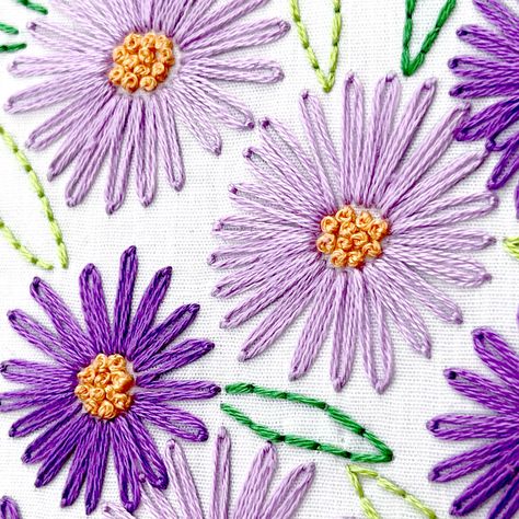 Shop the all-inclusive embroidery supplies kit HERE. The September birth flower is the Aster! This flower has pretty spindly petals and blooms in various colors in the pink and purple family. A burst of end-of-summer color and energy! Stitch this design for yourself or gift it to a friend who was born in September! The September Aster is great for beginner and seasoned crafters alike. Skill level: Beginner. You can do it! Pattern size: 5” x 5” (approximately 13 cm x 13 cm) Basic embroidery stitc September Embroidery Design, Aster Flower Embroidery, Aster Embroidery Pattern, Aster Flower Embroidery Pattern, Orange Flower Embroidery, Purple Flower Embroidery, Ombre Embroidery, Embroidery Violet Flower, Blue And Purple Flower Embroidery