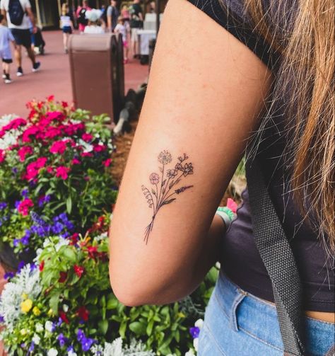 Tattoos With Subtle Color, Wild Flower Tattoo Back Of Arm, Wildflower Friendship Tattoo, Back Of Arm Womens Tattoo, Different Arm Tattoo Placement, Back If The Arm Tattoos, Birthday Symbols Tattoos, Flower Tattoos Behind Elbow, Minimalist Tattoo Wildflower