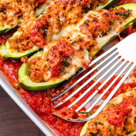 Zucchini boats stuffed with sausage, breadcrumbs, onion, cheese, and garlic, topped with marinara and mozzarella, and baked until bubbly. Zucchini Boats Sausage, Sausage Stuffed Zucchini Boats, Zucchini Boats Recipe, Sip And Feast, Sausage Marinara, Zucchini Boat Recipes, Veggie Side Dish Recipes, Stuffed Zucchini Boats, Yellow Squash Recipes