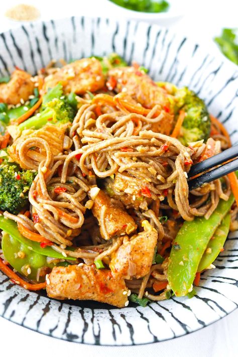 These Spicy Peanut Soba Noodles are made with fragrant aromatics, snow peas, broccoli, carrots, perfectly seasoned chicken pieces, soba noodles and a delightful creamy peanut sauce that’s spicy-sweet with a hint of tang! It’s easy to make in 30 minutes and lip-smacking tasty! #sobanoodles #noodles #highprotein #spicy #asianfood #healthy #peanutsauce #easyrecipes #highfiber #highproteinmeals #soba #stirfry #chickennoodles | That Spicy Chick Peanut Soba Noodle Recipe, Spicy Peanut Broccoli Chicken Noodles, Bjs Spicy Peanut Soba Noodles Recipe, Soba Noodles With Chicken, Soba Noodles With Peanut Sauce, Chicken And Soba Noodles, Chicken Soba Noodles Stir Fry, Chicken Soba Noodles, Soba Noodle Recipe Chicken