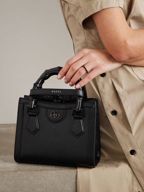 Gucci's 'Diana' tote was first introduced in 1991 and has since become an iconic style. Made from textured-leather, it's distinguished by its square shape, bamboo top handles - a house signature since 1947 - and 'Double G' hardware. Inside you'll fit your phone, makeup compact and keys. Black Gucci Purse, Black Gucci Bag, Gucci Diana, Gucci Mini Bag, Expensive Bag, Branded Outfits, Luxury Bags Collection, Gucci Purse, Gucci Brand