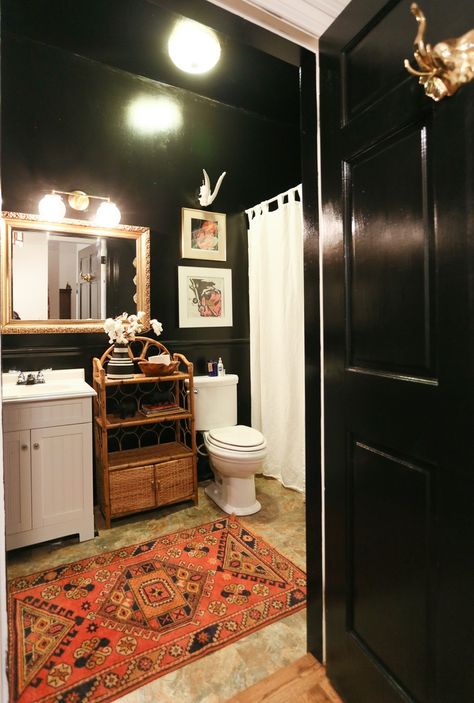 Bold dark bathrooms can totally work if done right and planned well. Black walls, when met with white linens and fixtures and a statement vintage rug make this space unforgettable and a color scheme that you never knew you wanted! House Tour: Southern, Bohemian Charm in Nashville | Apartment Therapy Brighten Bathroom, Small Dark Bathroom, Windowless Bathroom, Moore House, Dark Bathrooms, Eclectic Bathroom, Frameless Shower Doors, Dark Walls, Vintage Bathrooms