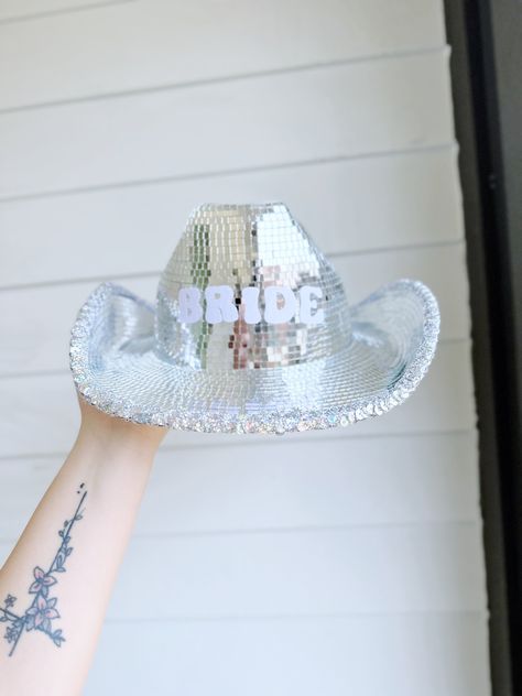 This disco ball cowgirl hat for your bachelorette party is the perfect add on to any bachelorette trip outfit for the bride. The cowgirl disco hat makes the perfect bride outfit for a groovy last disco bachelorette party theme. Add to the last disco decor or gift the bride this disco ball cowgirl hat for the bach party, bridal shower, or engagement gift. Cowboy Disco Bachelorette Party, Disco Bach Party, Bachelorette Gift For Bride, Brides Last Disco, Disco Cowgirl Outfit, Beyonce Bachelorette, Bride Cowgirl Hat, Disco Cowgirl Bachelorette Party, Disco Hat