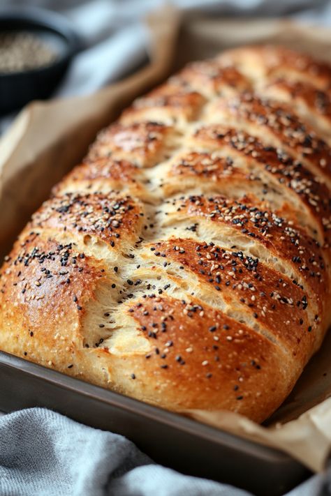 Freshly baked braided bread topped with black and white sesame seeds in a baking tray. How To Bake Bread Machine Dough In The Oven, Bread Machine Everything Bread, Everything Bread Machine Recipe, Fun Bread Machine Recipes, Bread Machine Crusty Bread, Bread Oven Recipes, Breadmaker Bread Recipe, Simple Bread Machine Recipes, Bread Machine Whole Wheat Bread Recipe