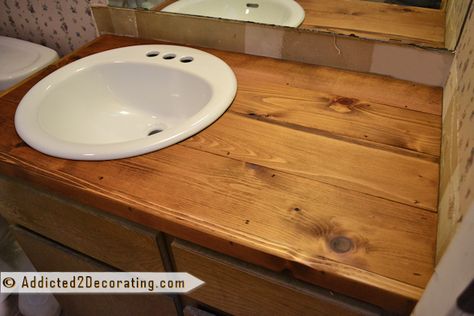 Wood countertop in bathroom made with cedar fence pickets & plywood:  4 cedar fence pickets – $7.88 1″ x 2″ x 8′ cedar board – $2.46 2′ x 4′ x 3/4" plywood – $15.65 Golden Oak stain – $4.78 Liquid Nails – $3.34 TOTAL -  $34.11 Diy Bathroom Sink, Diy Wood Countertops, Bathroom Sink Bowls, Countertop Makeover, Vanity Makeover, Bathroom Vanity Makeover, Diy Bathroom Vanity, Wood Countertop, Cedar Fence