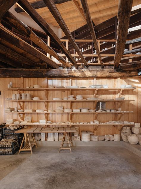 Pottery Display, Timber Cabin, Coimbra Portugal, Cozy Restaurant, Timber Beams, Pottery Workshop, Brick Facade, Natural Ventilation, Wood Burner