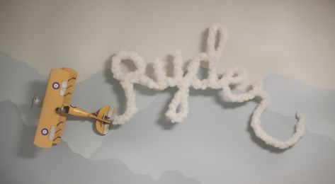 DIY name hanging plane smoke Diy Aviation Decor, Vintage Planes Nursery, Diy Airplane Decor, Boy Nursery Airplane Theme, Travel Theme Nursery Boy, Airplane Room For Boys, Vintage Plane Baby Shower Ideas, Airplane Baby Announcement, Baby Boy Airplane Nursery