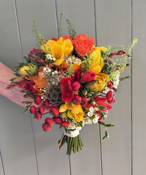 A feast of colour for Autumn! Red and Yellow Freesia were mixed with Ranunculus, Roses and Berries for this country posy. Red And Yellow Bouquet, Yellow Freesia, Prom Flowers Bouquet, Yellow Bouquets, Red Bouquet, Prom Flowers, Wildflower Bouquet, Butter Yellow, Pink And White Flowers