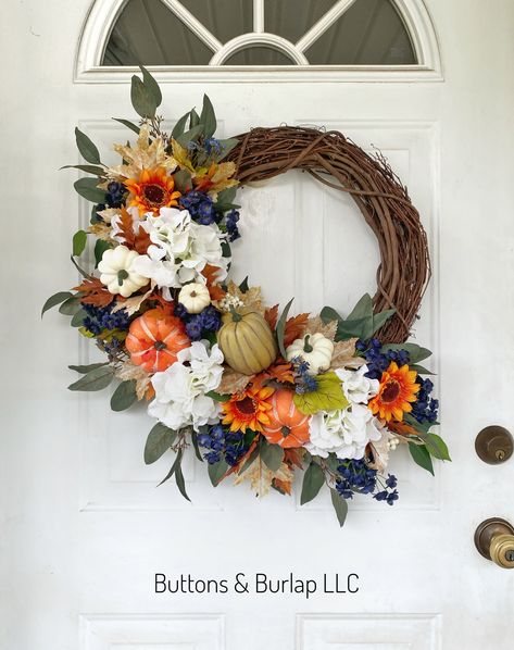 This fall wreath has a variety of greens, faux pumpkins, hydrangeas and a few seeded berry stems. Measuring 23” wide and 27” in length this wreath has an order processing time of 2 weeks. Blue And Orange Fall Decor, Fall Flower Wreath, Easy Thanksgiving Table Decor, Orange Fall Decor, Thanksgiving Table Decor Ideas, Blue Fall Decor, Fall Decor Wreaths, Creative Wreaths, Thanksgiving Table Decor