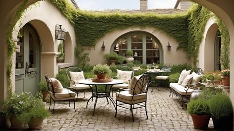 27 Breathtaking Mediterranean Patios to Inspire Your Home Retreat - Peak Patio Life Spanish Patio Furniture, Spanish Colonial Courtyard, Spanish Courtyard Ideas, Spanish Style Patio Outdoor Spaces, Mediterranean Patios, Spanish Patio Ideas, Cobblestone Flooring, Spanish Style Patio, Spanish Style Courtyard