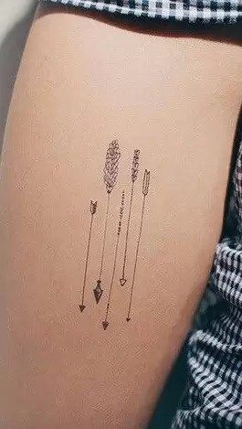 The Meanings Behind The Arrow Tattoo: A Growing Trend 5 Arrow Tattoo Design, 4 Arrows Tattoo, Strength Arrow Tattoo For Women, Triple Arrow Tattoo, Birth Flower Arrow Tattoo, Double Arrow Tattoo, Simple Arrow Tattoos For Women, Arrow Tattoo Meaning, Fine Line Arrow Tattoo Design