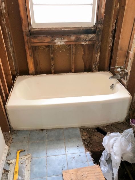 white cast iron tub in gutted bathroom Cast Iron Tub Bathroom Ideas, Bathroom Tub Tile Surround, Refinished Cast Iron Tub, Bathroom With Cast Iron Tub, Bathroom Remodel Keeping Old Tub, Tiling Bathtub Surround, Tub Shower Combo With Ledge, Bathfitters Bathtubs, Cast Iron Bathtub Ideas