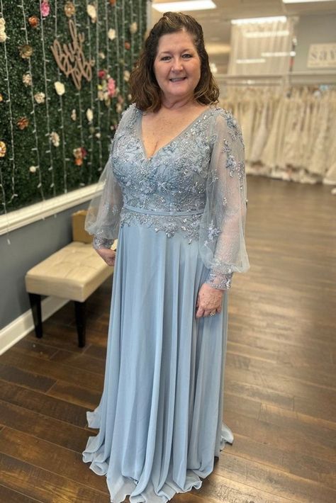 Dusty blue a-line chiffon mother of the bride dress, mother of the groom gown and wedding guest outfit with lace long sleeve blouson and silver appliques | Mother of the Bride Dresses — Savvi Formalwear&Bridal | Raleigh, North Carolina Wedding Dresses Dusty Blue Mother Of The Bride Dress Long, Mother Of The Groom Blue Dresses, Silver Mother Of The Bride Dress, Mother Of Bride Blue Dress, Mother Of The Bride Blue Dress, Mother Of The Bride Dress Blue, Mother In Law Dresses For Wedding, Light Blue Mother Of The Bride Dress, Dusty Blue Mother Of The Bride Dress