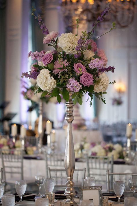 Tall purple and white floral centerpiece Tall Purple Flower Arrangements, Lilac Floral Arrangements Wedding, Purple Flower Centrepiece, Tall Purple Centerpieces, Lavender Floral Centerpieces, Purple Floral Arrangements Centerpieces, Purple Centerpieces Quinceanera, Purple Centerpiece Wedding, Tall Centerpiece Wedding