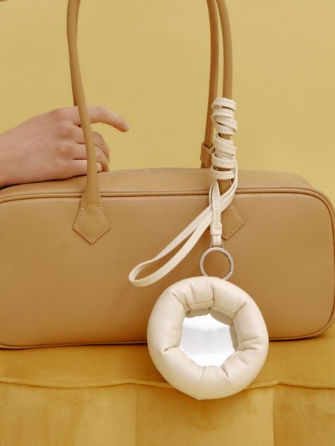 KOIMOOI is a contemporary brand that expresses our shared silhouette of this era in the most me-like way, respecting diversity. - Mirror bag charm with a long strap- Plump padded donut frame- Mini storage slot at the back- Casual and unique mood <form class=stretch mx-2 flex flex-row gap-3 last:mb-2 md:mx-4 md:last:mb-6 lg:mx-auto lg:max-w-2xl xl:max-w-3xl> </form> Fashion Accessory Bag With Detachable Handle, Modern Pouch Bag With Detachable Handle, Playful Shoulder Bag With Removable Pouch, Bag Accessories Keychain, Innovative Accessories, On-the-go Pouch With Detachable Handle, Mirror Bag, Bag Mirror, The Row Bag