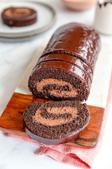 This Double Chocolate Swiss Roll recipe is made for chocolate lovers. It's the perfect weekend or holiday cake that both kids and adults adore. For the decoration we simply coated it in chocolate, however, feel free to sprinkle with chocolate shavings too. #jernejkitchen #doublechocolate #chocolateswissroll #swissrollcake #dessert Chocolate Swiss Roll Recipe, Swiss Roll Recipe, Chocolate Swiss Roll, Chocolate Roll Cake, Swiss Roll Cake, Cake Roll Recipes, Holiday Cake, Chocolate Roll, Yule Log