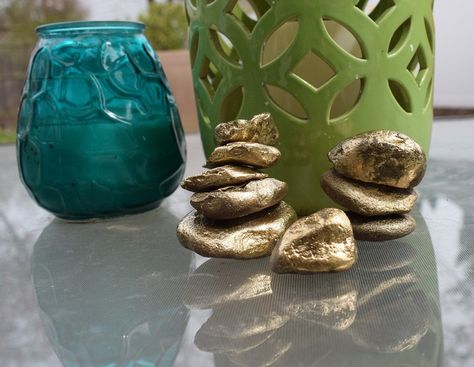 Today I will show you how I took some basic rocks & stones from the backyard (luckily, my yard has plenty of them for projects like this!), stacked them up in a tall tower formation and spray-painted them gold ( this is my fave spray paint). This project was so much fun that I am definitely intending to make more of these babies. In fact, I have some huge rocks boulders that I would love to use to make a jumbo version! The jumbo version could go right in the flower beds!… Metal American Flag, Summertime Decor, Pom Pom Decorations, Floating Mantel, Faux Panels, Picture Molding, Bee Skep, Hometalk Diy, Crate Shelves