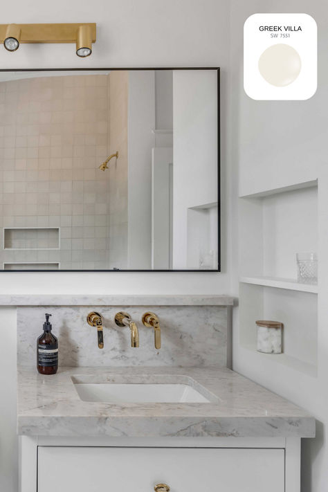 Greek Villa walls pair beautifully with the mix of cream and black tiles on the tub, complemented by a white vanity and brass accents for a sophisticated finish. #GreekVilla #InteriorDesign #HomeDecor #NeutralPalette #HomeRenovation #PaintColor #PaintColorInspiration #Bathroom #PaintInspiration #DesignDetails #NeutralTones #PaintTrends #BathroomDesign #InteriorDesignInspo #WhiteInteriors Greek Villa Walls, Greek Villa, Paint Trends, Greek Villas, Paint Color Inspiration, Black Tiles, White Vanity, Color Inspo, Brass Accents