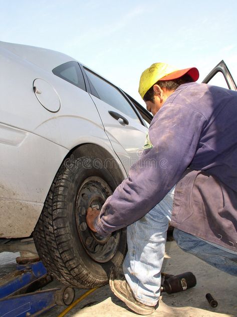 Changing tires. A mechanic changing a flat tire #Sponsored , #SPONSORED, #AD, #tires, #tire, #flat, #Changing Graphic Art Prints, Flat Tire, Tires, Graphic Art, Royalty Free Stock Photos, Vision Board, The Way, Stock Images, Art Prints