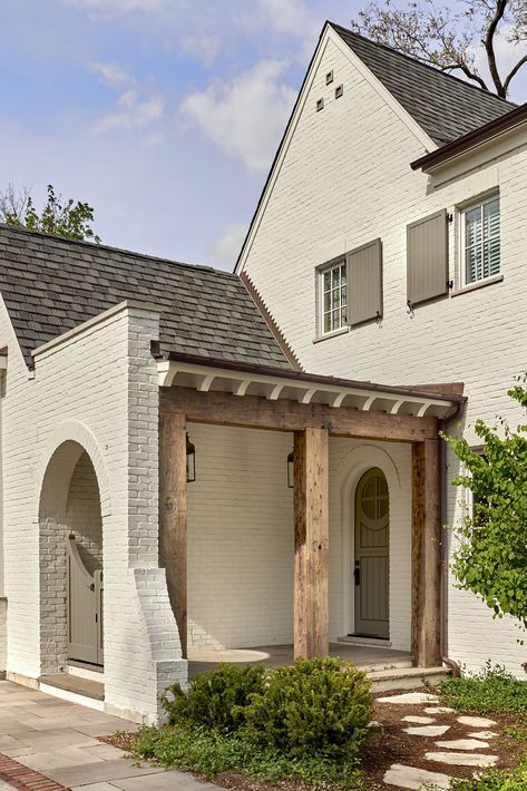 Two-story white painted brick home with grey shutters and reclaimed wooden beams exudes old-world charm, creating a comfortable and inviting retreat in the western suburbs of Chicago. Cape Dutch Style Homes, White Painted Brick, Cape Dutch, Transitional Exterior, Transitional Farmhouse, Dutch Style, Interior Design Guide, Brick Home, Backyard Porch